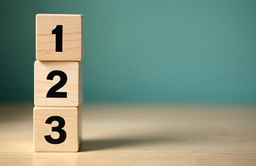 Three wooden blocks stacked, displaying numbers 1, 2, 3. Simple visual aid representing steps, process, instruction system. Education, business presentations, displaying simple instructional system,