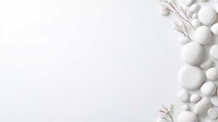 Smooth, white stones and delicate dried branches are arranged along the right edge of a white background. The composition is minimalist and clean. The image is high-resolution, with even lighting. A