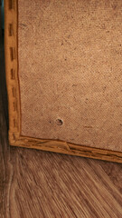 Back of painting showing canvas and wooden frame of sofa