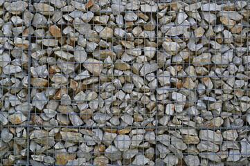 Natural gravel stone texture background with small pebbles and gray rocks. Close-up of rough surface used for construction, landscaping, or design materials.