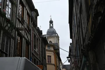 Fotobehang Smalle Straten Historic European city architecture with narrow streets and tall buildings under cloudy sky. Old town view — concept of travel, culture, urban lifestyle, and architectural heritage.  © Анна Климчук