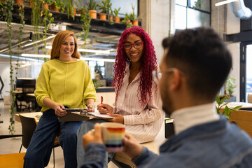 Multi-ethnic team collaborating in modern coworking space