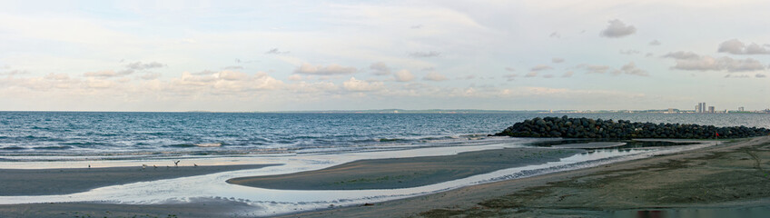 Panoramic view of the Gulf of Mexico with coastline, sand, horizon, embankment and sky during summer day in Veracruz