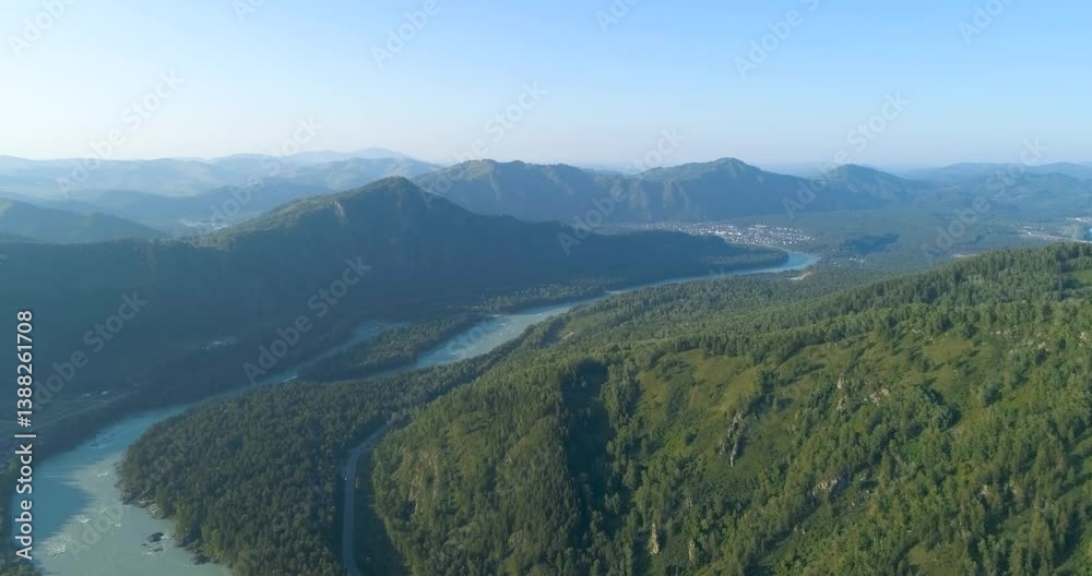 Poster river runs through a valley with mountains in the background. the river is green and clear. the moun