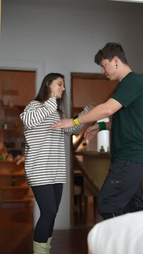 A couple joyfully dancing in a stylish interior, radiating affection and happiness