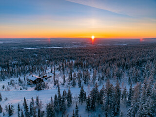 Aerial view of beautiful winter landscape in Lapland during sunset.