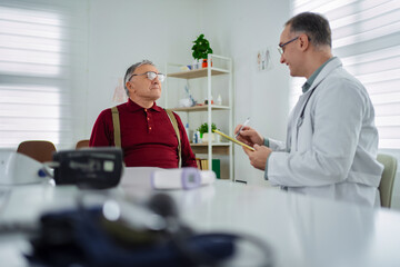 Doctor conducts a health checkup with an elderly patient indoors