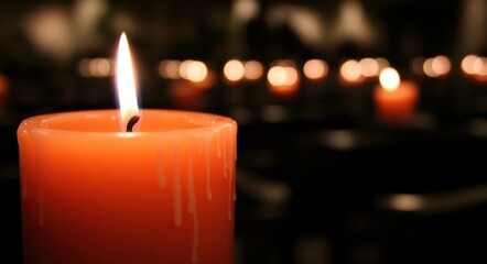 The background is blue with a flame from numerous burning candles