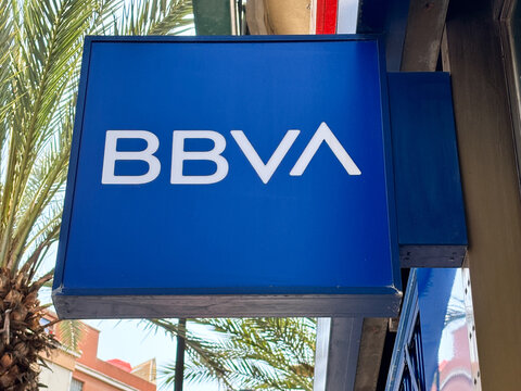 BBVA bank sign displayed prominently on a building exterior surrounded by palm trees showcasing modern branding and urban lifestyle concept