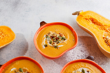 Traditional autumn butternut squash soup with seeds.