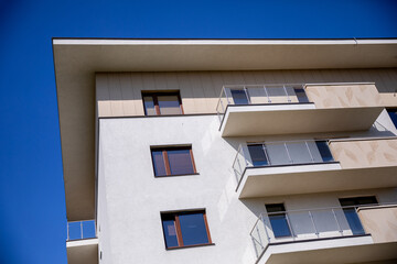 A Stunning Modern Apartment Building Set Against a Clear and Bright Blue Sky Above