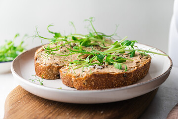 Rye toasts with a turkey pate and microgreens, healthy breakfast