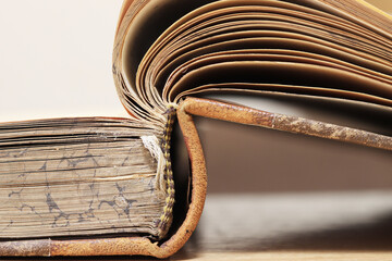 Close-up of two antique books with worn pages and textured covers