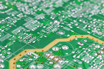 Green circuit board close-up with electronic components and connectors
