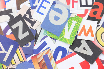 Colorful collage of various cut-out letters in a random arrangement