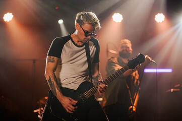 Guitarist playing electric guitar on stage during live performance