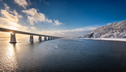 Obraz premium snowy sky over sunny dutch lake bridge