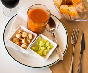 Traditional Spanish dish Gazpacho, made from tomato puree, is served with croutons and sliced cucumber