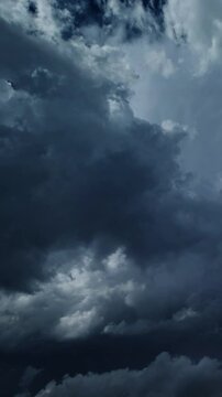 Lot of lightning during a thunderstorm. Storm clouds are moving fast on the viewer, timelapse. Vertical video