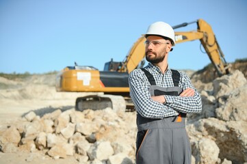 Worker and quarry in background