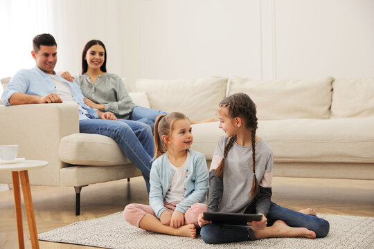 Family in living room with comfortable sofa - Powered by Adobe
