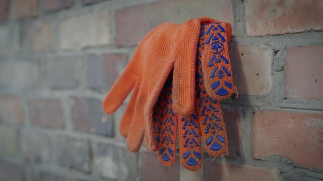 Orange Work Gloves Hanging on Brick Wall, Construction Worker Break, Building Site Safety Equipment