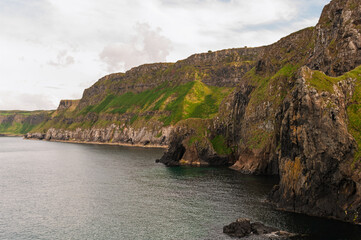 A rocky shoreline with a body of water in the background