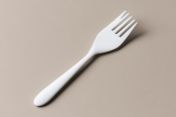 White plastic fork on a neutral background