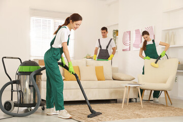 Professional cleaning service team working in room