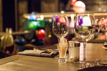 Elegant restaurant table setting with wine glasses and warm ambient lighting
