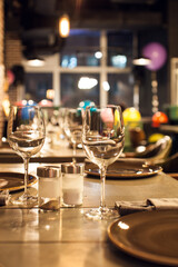 Elegant restaurant table setting with wine glasses and warm ambient lighting