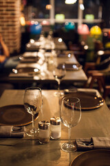 Elegant restaurant table setting with wine glasses and warm ambient lighting