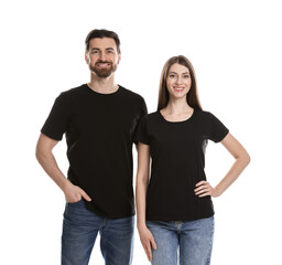 Fototapeta premium Woman and man wearing blank black t-shirts on white background. Mockup for design