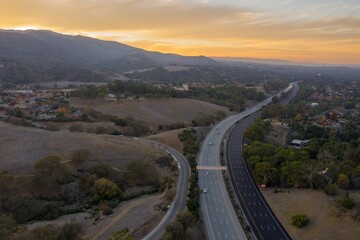 Aerial view of Interstate 280 with cars moving in both directions, connecting a residential area in...