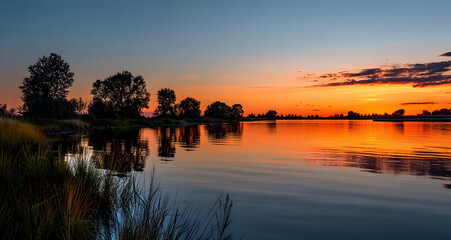 Sunset over a tranquil delta with warm hues reflecting on a peaceful river