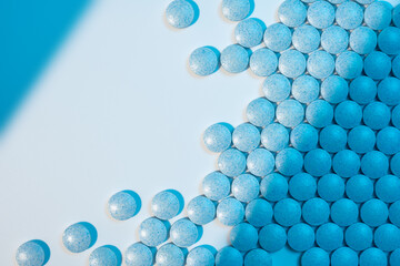 Close up of medical pills on white background with blue shadows