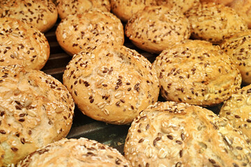 Fresh whole grain bread rolls. Crunchy baked buns with seeds. Healthy artisan bakery products....