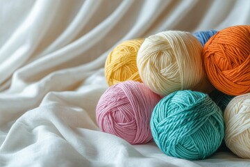 Colorful yarn balls resting on white fabric inspiring creativity