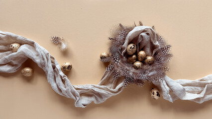 Quail eggs arranged in a decorative nest adorned with feathers and surrounded by soft linen fabric on a beige background. Minimalist Easter-themed design with natural elements.