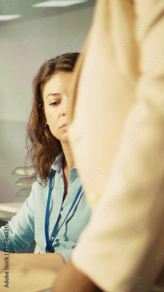 Poster vertical video office clerk at computer desk reading documentation files, solving tasks. staff membe
