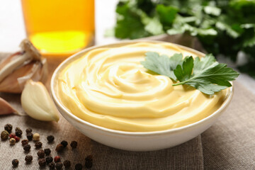 Delicious mayonnaise sauce with parsley in bowl on table, closeup