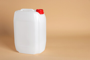 One white plastic canister on beige background, space for text