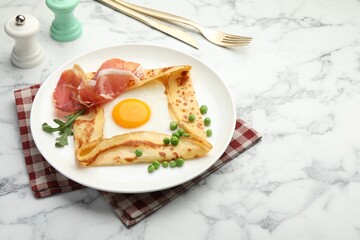 Delicious crepe with egg, bacon, arugula and green peas on white marble table, space for text