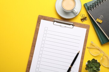 Flat lay composition with checklist on yellow background