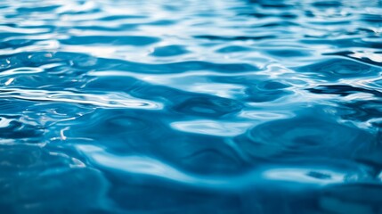Reflective water surface with subtle waves in azure blue. Water background