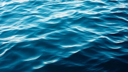 Obraz premium Reflective water surface with subtle waves in azure blue. Water background
