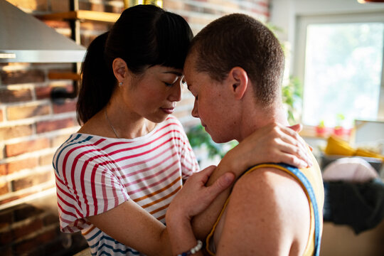 Loving lesbian couple sharing intimate moment at home