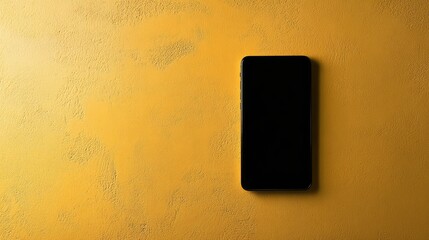 Top view of modern phone with black blank screen on yellow surface, creative flat lay with vibrant copy space
