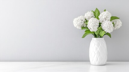 A white vase with a bouquet of white flowers on a minimalist table against a light gray wall, and elegant and serene interior design concept.