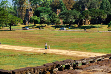 Siem Reap, Cambodia, 12 Jan 2024: the territory of the Angkor Tom Temple complex. A European mother and daughter are walking through an empty clearing.